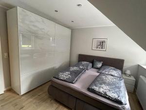 a bedroom with a bed with two pillows on it at Ferienwohnung Bayside in Edertal
