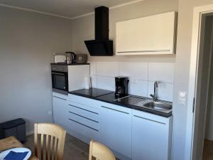 a small kitchen with a sink and a microwave at Ferienwohnung Bayside in Edertal +7 photos