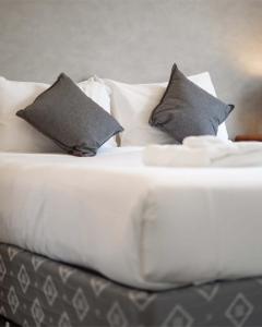 a white bed with two pillows on it at Remarkable Cross Road Retreat in Frankton