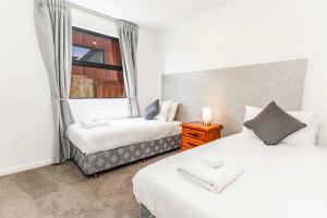a bedroom with two beds and a window at Remarkable Cross Road Retreat in Frankton +18 photos