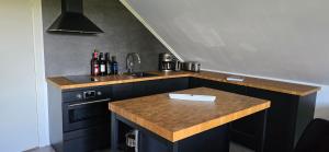 a kitchen with a wooden counter top and a sink at Apartment Feelgood in Billdal