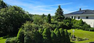 a house with a lot of trees in the yard at Apartment Feelgood in Billdal