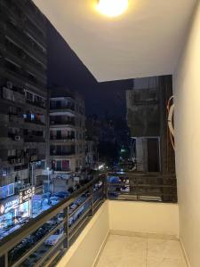 a balcony with a view of a city at night at Lovely Rivera Room with Breakfast in Cairo