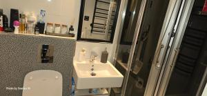 a small bathroom with a sink and a toilet at Apartment Feelgood in Billdal +18 photos