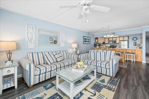 a living room with two couches and a table at One of a Kind Direct Bay Views From This 3 Bedroom Condo With Pool! in Ocean City