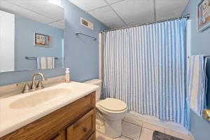 a bathroom with a sink and a toilet and a shower at One of a Kind Direct Bay Views From This 3 Bedroom Condo With Pool! in Ocean City +37 photos