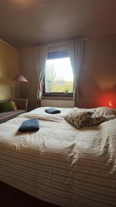 a bedroom with a large bed with two pillows on it at Guesthouse Leon in Tórshavn