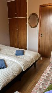 a bedroom with a bed with two blue towels on it at Guesthouse Leon in Tórshavn