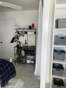 a room with white shelves and a room with a door at Cozy Studio in Miami