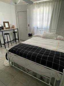 a bedroom with a bed with a plaid mattress at Cozy Studio in Miami