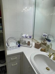 a bathroom with a sink and a mirror at Cozy Studio in Miami