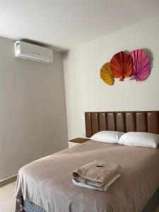 En eller flere senge i et værelse på Pousada Mariana