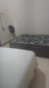 a room with a bed and a mattress sidx sidx sidx at Hospedaria Meu lar 2 in Rio das Ostras