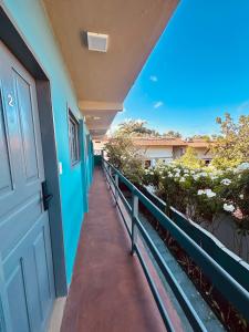 a hallway of a building with a blue door at Sol da pipa - suítes in Pipa