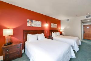 two beds in a hotel room with red walls at Hotel McCall in McCall +10 photos