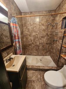 een badkamer met een douche, een toilet en een wastafel bij Casa Vizcaino in Ensenada +14 foto's