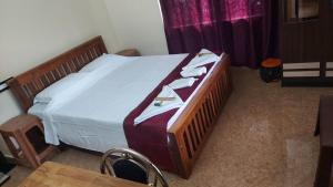 a bedroom with a bed with towels on it at Blue Hills View in Attappādi