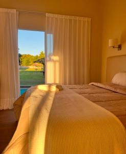 En eller flere senge i et værelse på Complejo Bohio