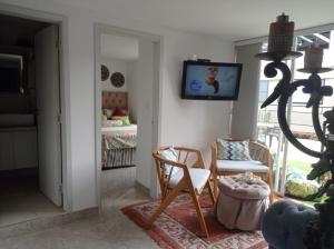a living room with a tv on the wall at My Bunker in Cali