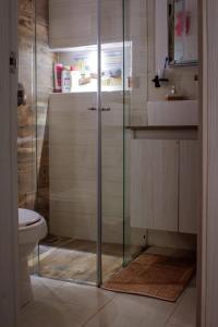 a bathroom with a glass shower and a toilet at My Bunker in Cali +12 photos