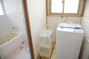 a bathroom with a sink and a washing machine at 宇都宮ゲストハウス花ニ嵐 Guesthouse Hana ni Arashi in Utsunomiya +40 photos