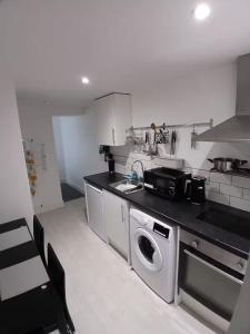 a kitchen with a sink and a dishwasher at Elegant Broadway Retreat w Parking & Dog Friendly in Broadway