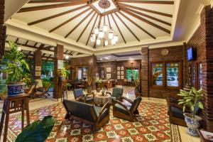 日惹的住宿－杜達精品別墅酒店，一个带桌椅和吊灯的大型大堂