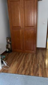 a room with a wooden cabinet and a wooden floor at MALÔ - Queluz in Queluz