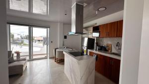 a kitchen with a sink and a counter top at Suite Rosedelco in Puerto Villamil