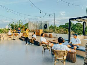 a group of people sitting in chairs on a roof at Viajero Santa Marta Hostel in Santa Marta