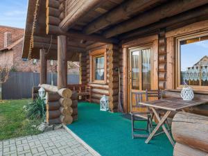 a log cabin patio with a wooden table and bench at Ute in Dankerode