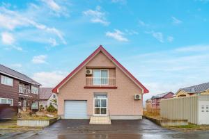 a house with a garage in a parking lot at Prostimo in Bibai