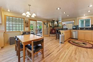a large kitchen with a wooden table and chairs at Otter Run in Bend