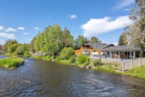 a river with houses on the side of it at Otter Run in Bend