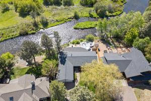 an overhead view of a house and a river at Otter Run in Bend