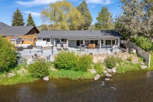 an aerial view of a house next to a river at Otter Run in Bend +34 photos