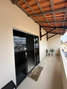 a room with a balcony with a table and chairs at Hotel Luci in Terra Santa