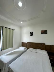 a bedroom with two beds and a window at Hotel Luci in Terra Santa