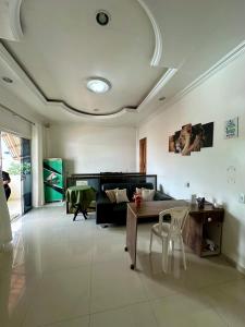 a living room with a table and a couch at Hotel Luci in Terra Santa