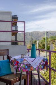 a table with a vase on top of a balcony at Hospedaje Jazmin Cosquín in Cosquín