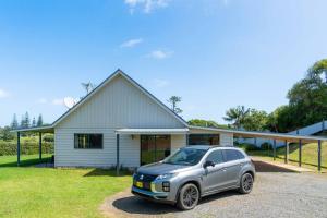 a silver car parked in front of a house at Ferny Lane House in Burnt Pine
