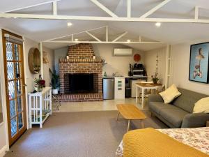 a living room with a couch and a fireplace at The Cosy Bungalow in Portarlington