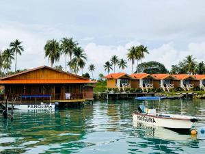 a group of houses on the water with boats at Panglima Resort Bum Bum Island, Semporna in Semporna