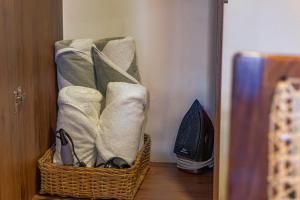 a basket with towels and shoes in a room at Premium Apartment in Tulum 2 Bedrooms Roof Top Pool - Aldea Zama in Tulum +26 photos