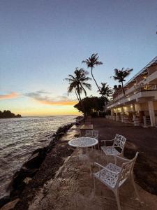 a table and chairs sitting next to the water at Beach House Goviyapana in Ahangama +20 photos