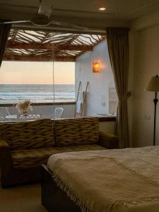 a hotel room with a bed and a view of the ocean at Beach House Goviyapana in Ahangama