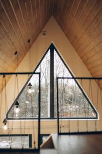 an attic room with a large window at Lofty House Mountain Tustan in Urych