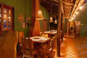 een restaurant met houten tafels en stoelen in een kamer bij Pousada das Cavernas in Iporanga