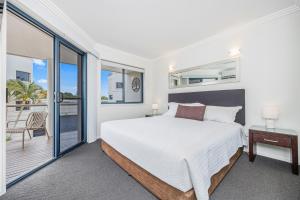 a bedroom with a bed and a balcony at Grange Resort Hervey Bay in Hervey Bay +47 photos