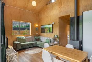 a living room with a couch and a table at Mountain View Barn with Spa in Queenstown